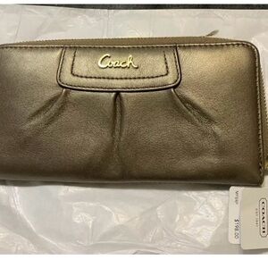 New with original price tag. Coach Gold/Teel zip wallet.
